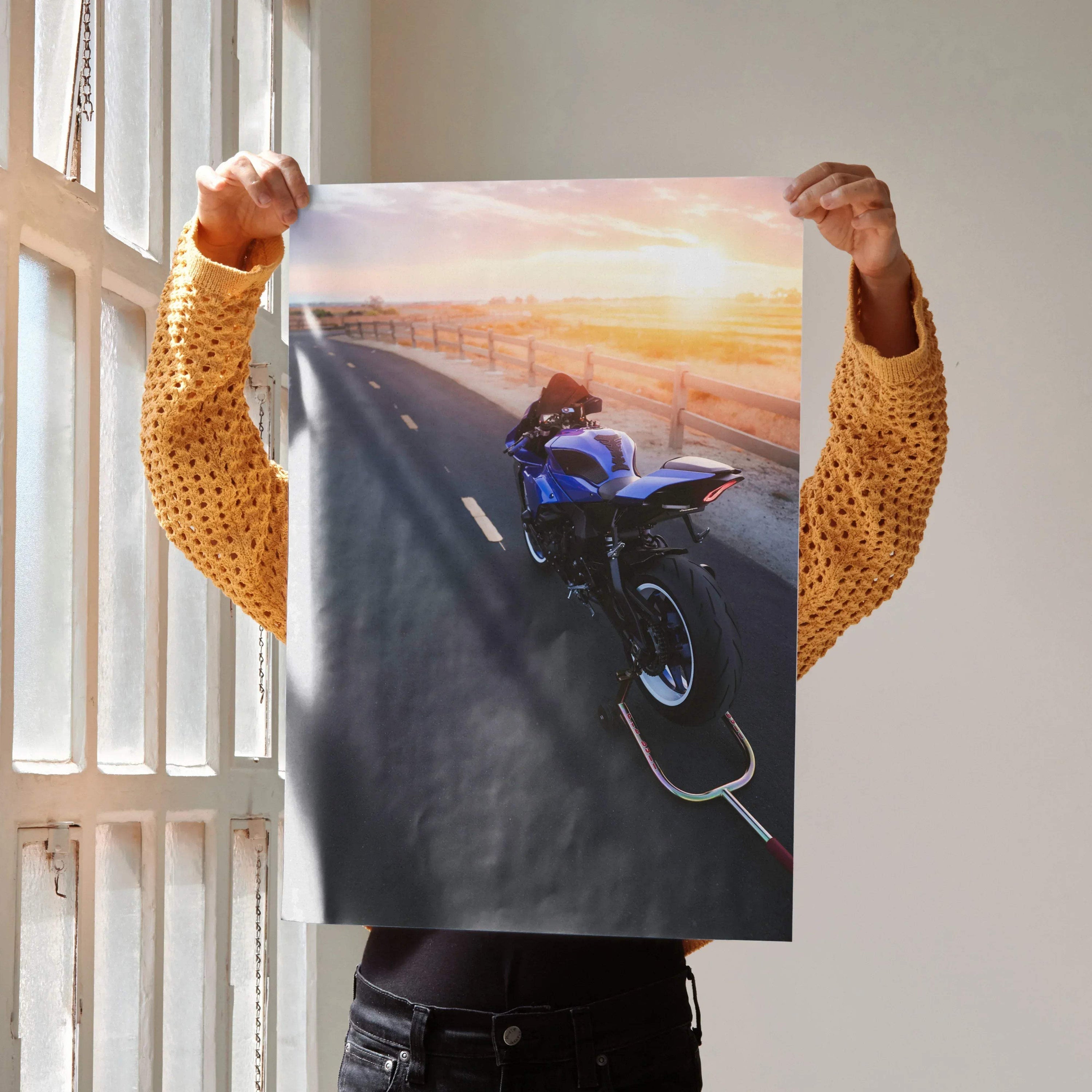Yamaha R1 motorcycle riding at sunset on road poster wall art with warm sky colors.
