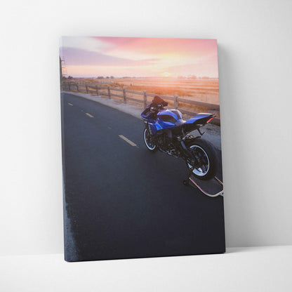 Blue Yamaha R1 motorcycle on asphalt road at sunset canvas wall art in vertical format.