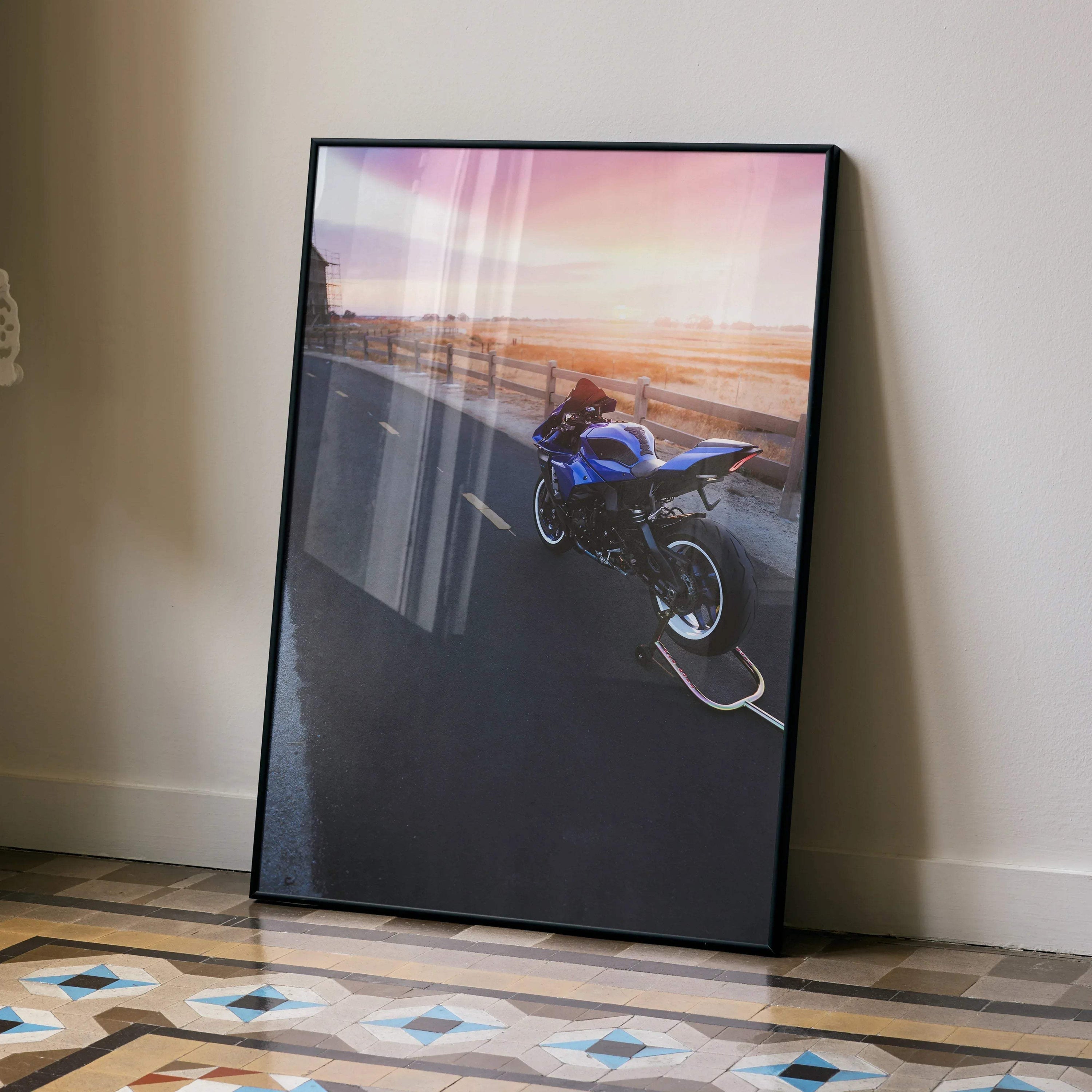 Yamaha R1 motorcycle poster with sunset background framed wall art leaning on beige wall.