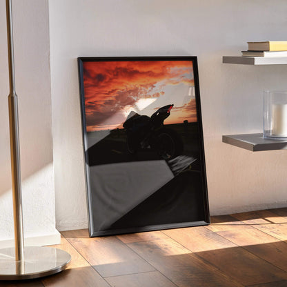 Yamaha R1 motorcycle silhouette against a dramatic red and orange sunset sky poster wall art in black frame.