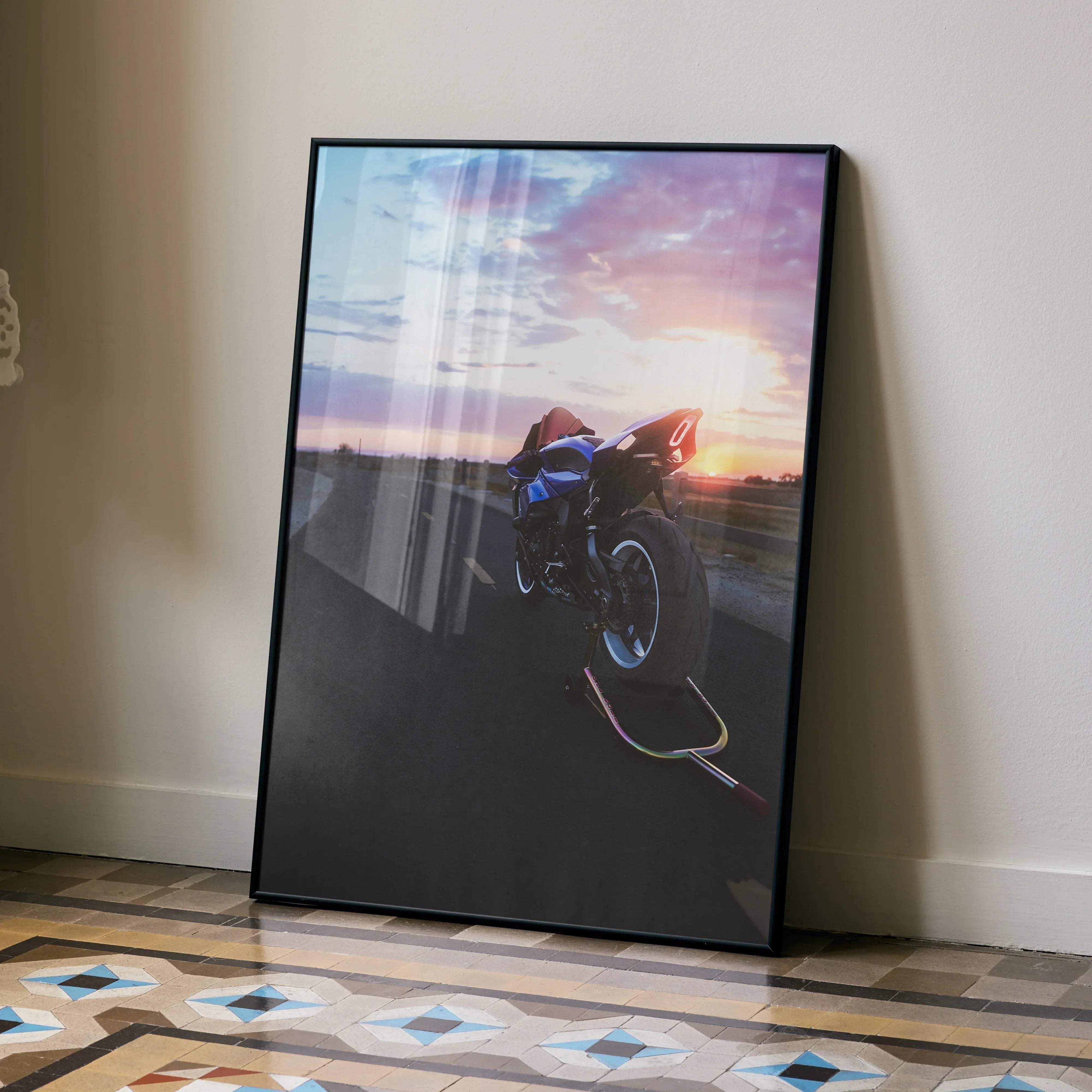 Black-framed poster featuring a blue Yamaha YZF-R1 motorcycle in mid-air against a vibrant sunset sky wall art print