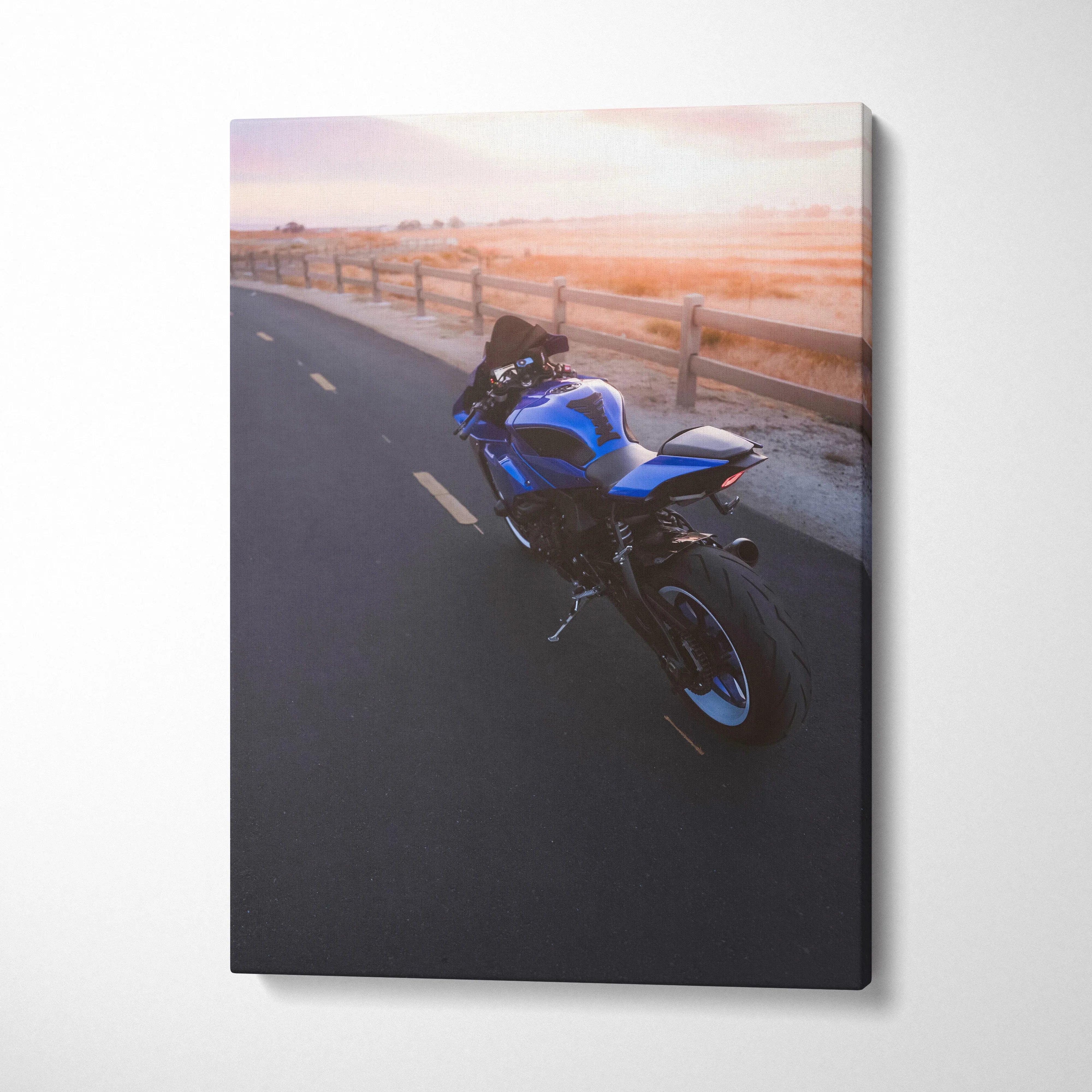 Blue Yamaha R1 motorcycle on asphalt road at sunset canvas wall art.