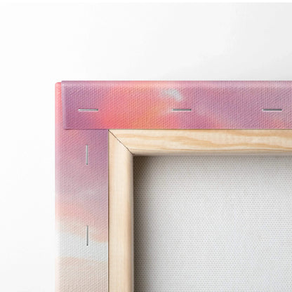 Close-up of wooden frame and pink sunset gradient canvas corner, vertical wall art detail.