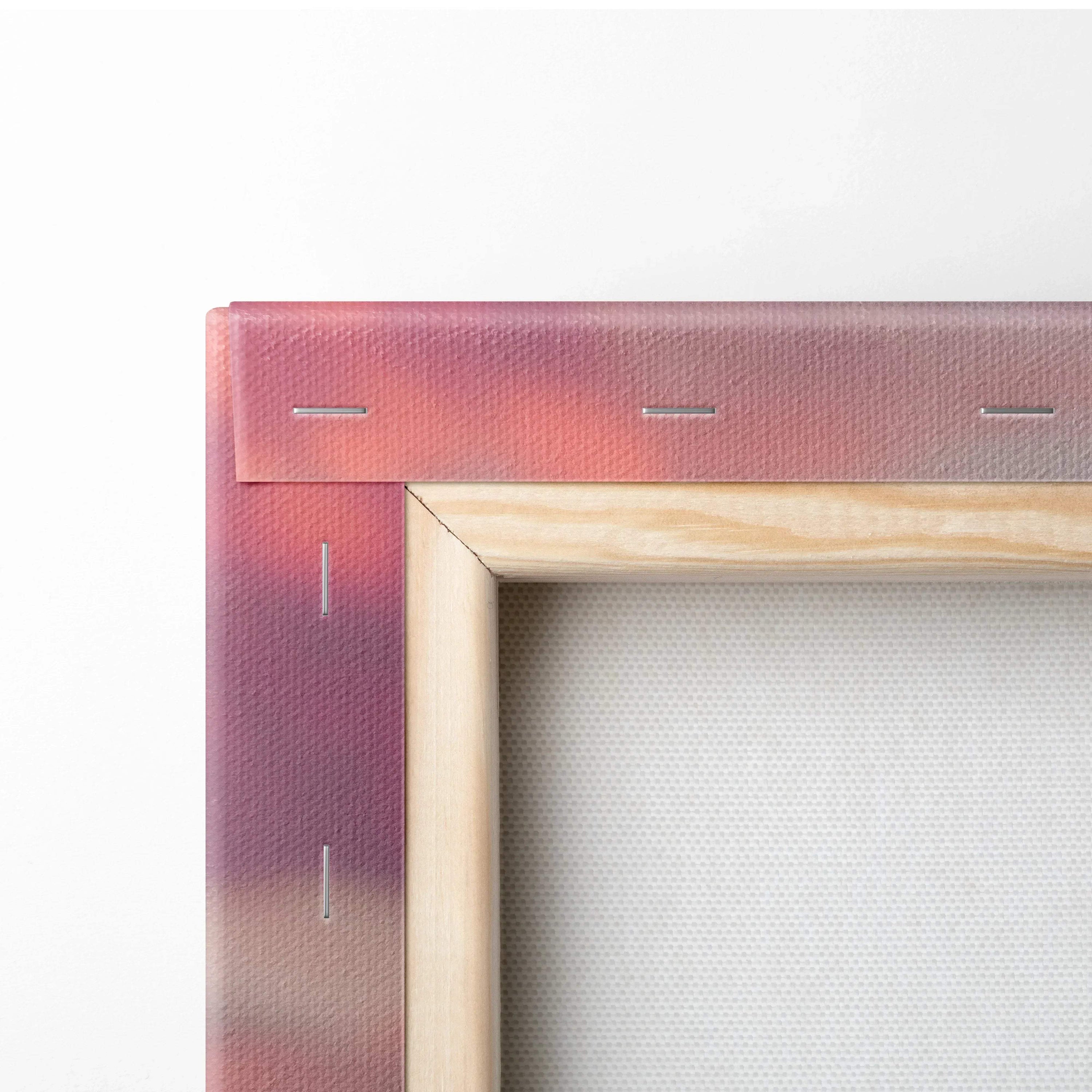 Close-up of wooden frame and stretched canvas corner with pink and orange sunset tones on canvas wall art.