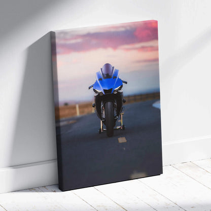 Vertical canvas wall art of blue Yamaha R1 motorcycle on road at sunset.