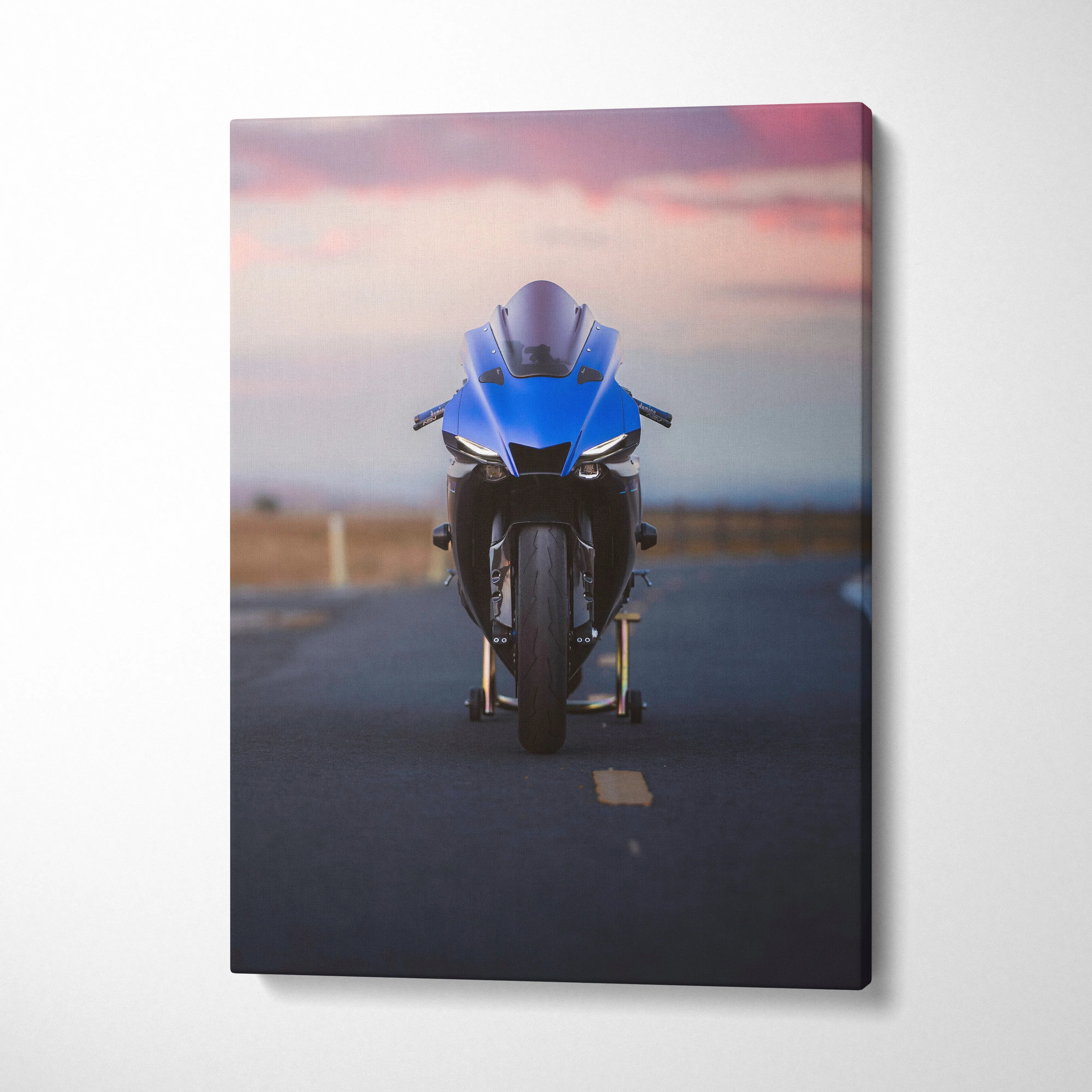 Blue Yamaha R1 motorcycle on road at sunset printed on vertical canvas wall art.