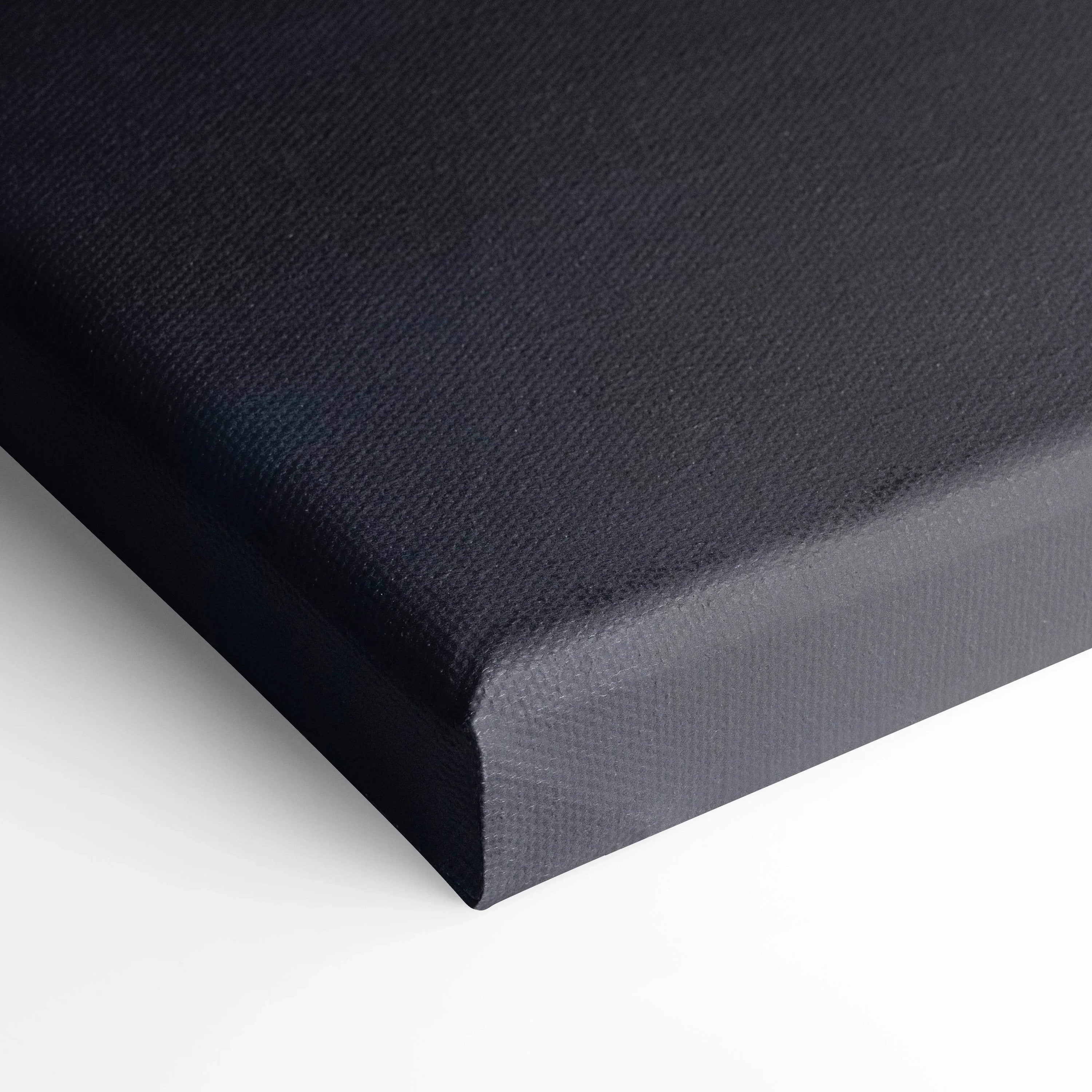 Close-up of black stretched canvas edge showcasing textured canvas art for wall decor.