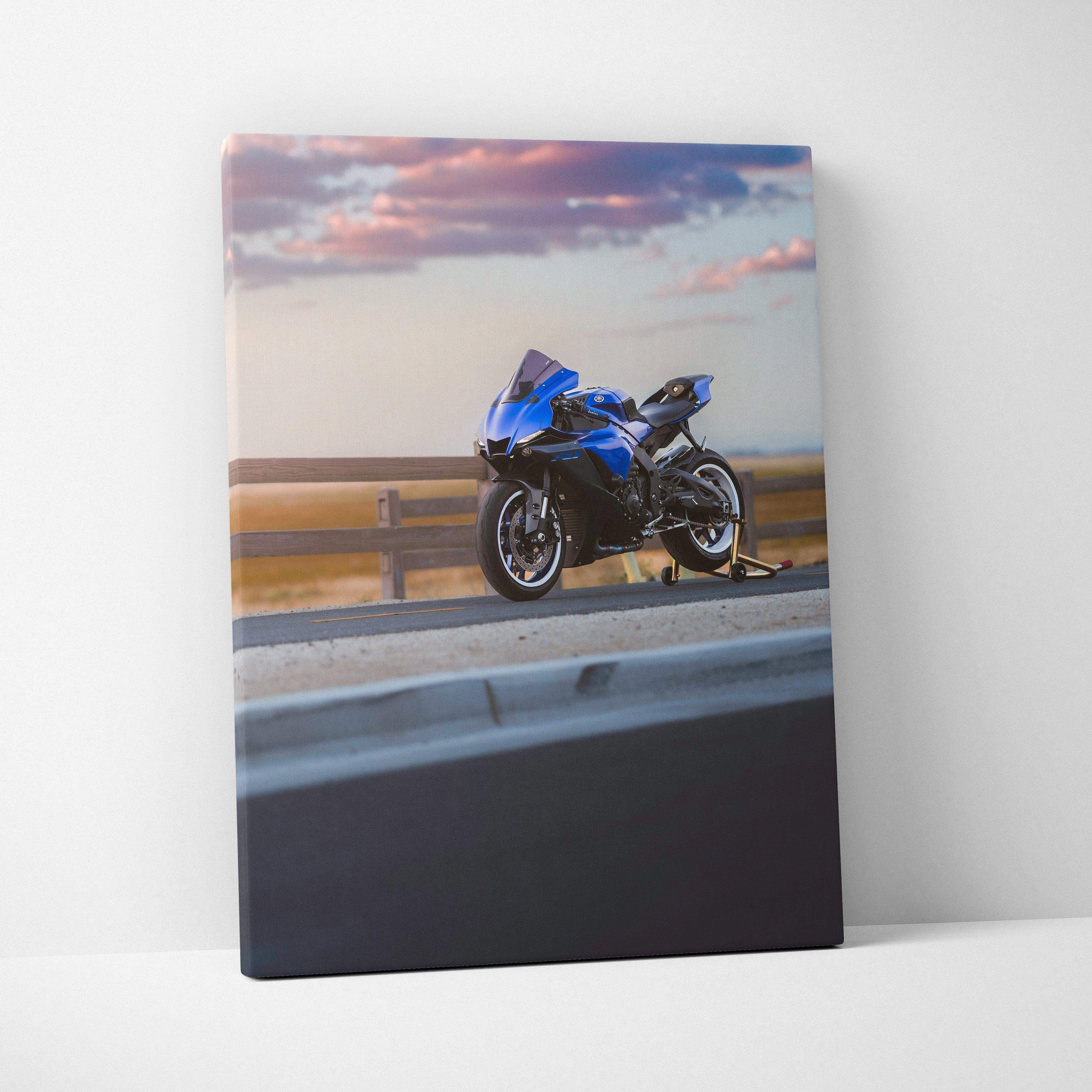Blue Yamaha R1 motorcycle on road at sunset printed on vertical canvas wall art.