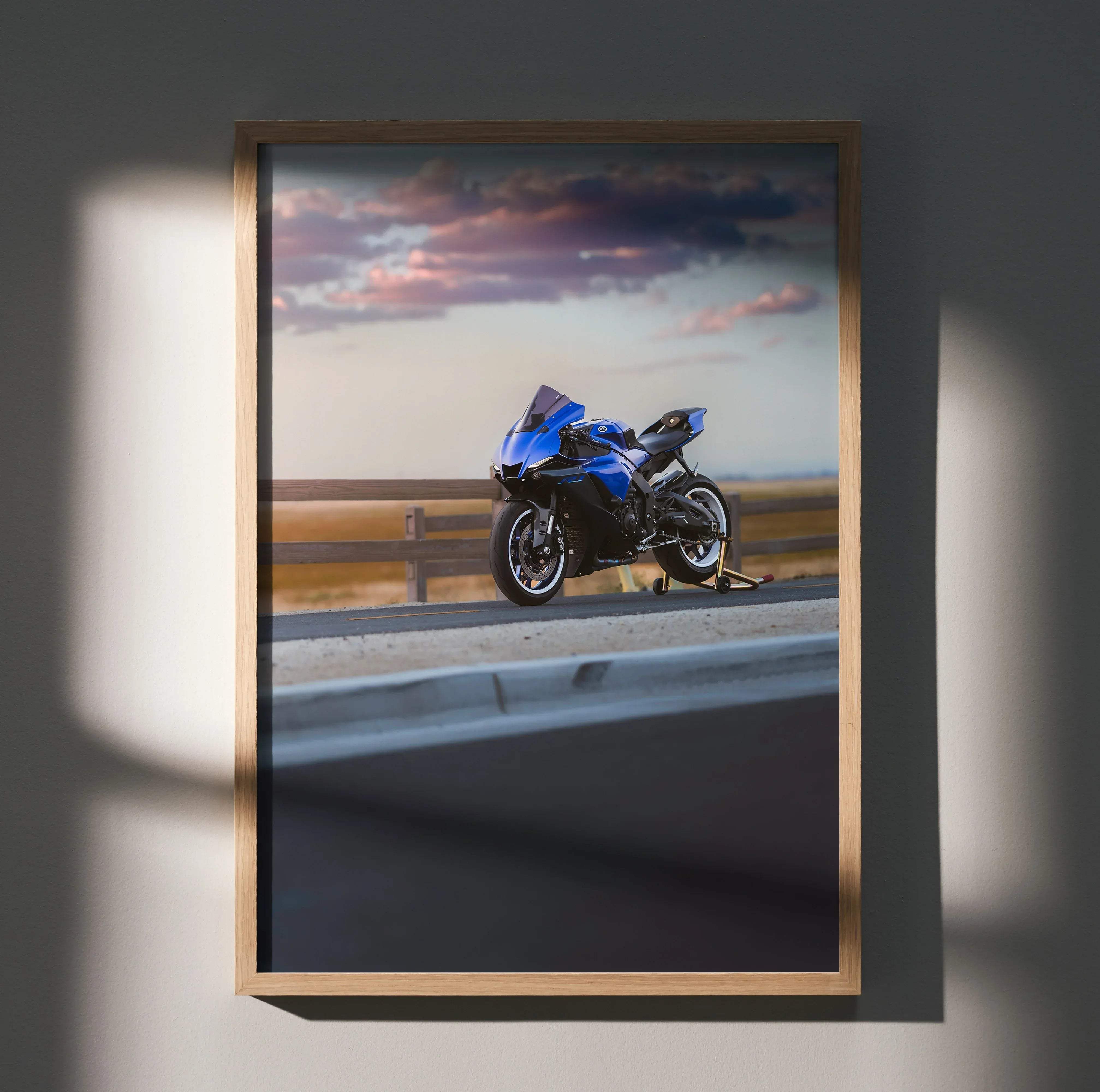 A framed photograph wall poster featuring a vibrant blue yamaha yzf-r1 sport motorcycle against a dusk sky