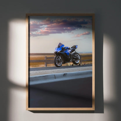 Blue Yamaha YZF-R1 motorcycle on road with dramatic sunset sky poster wall art.