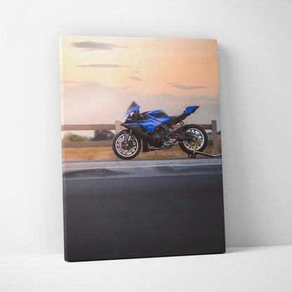 Blue Yamaha R1 motorcycle at sunset on vertical canvas wall art with road and sky background.