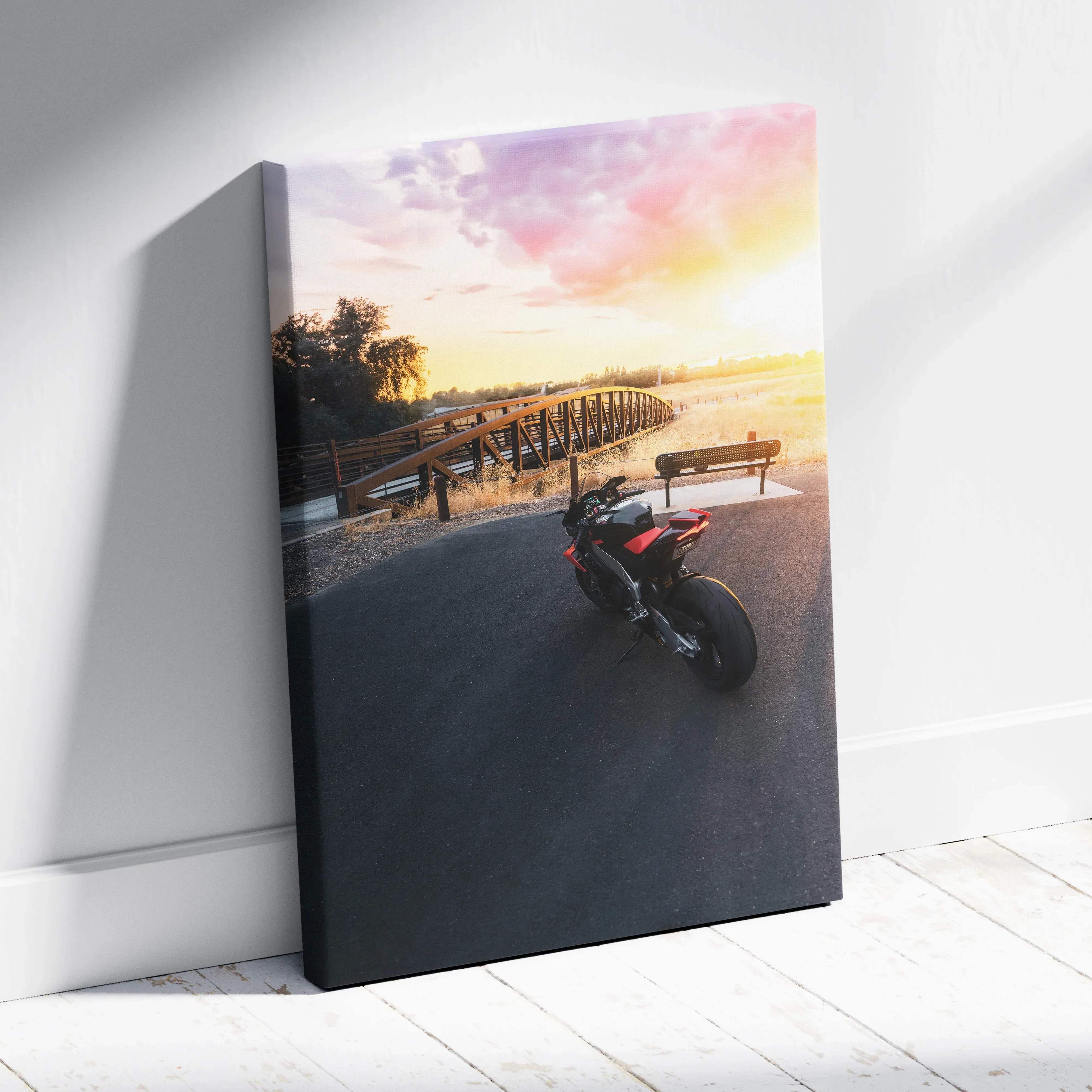 Canvas wall art vertical print of black and red aprilia rsv4 1100 factory motorcycle parked on road under warm sunset sky