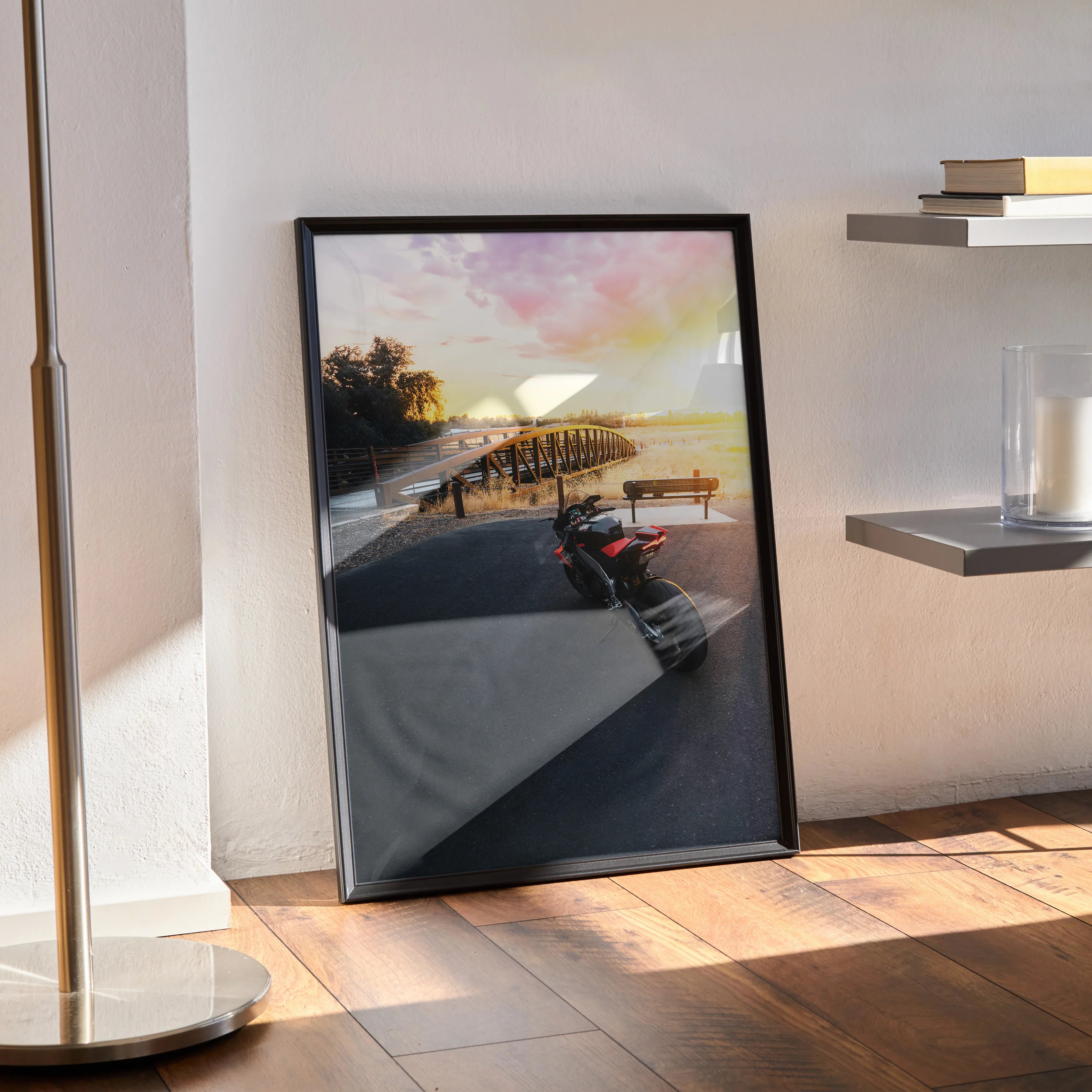 Aprilia RSV4 motorcycle poster with sunset background framed wall art leaning on floor.