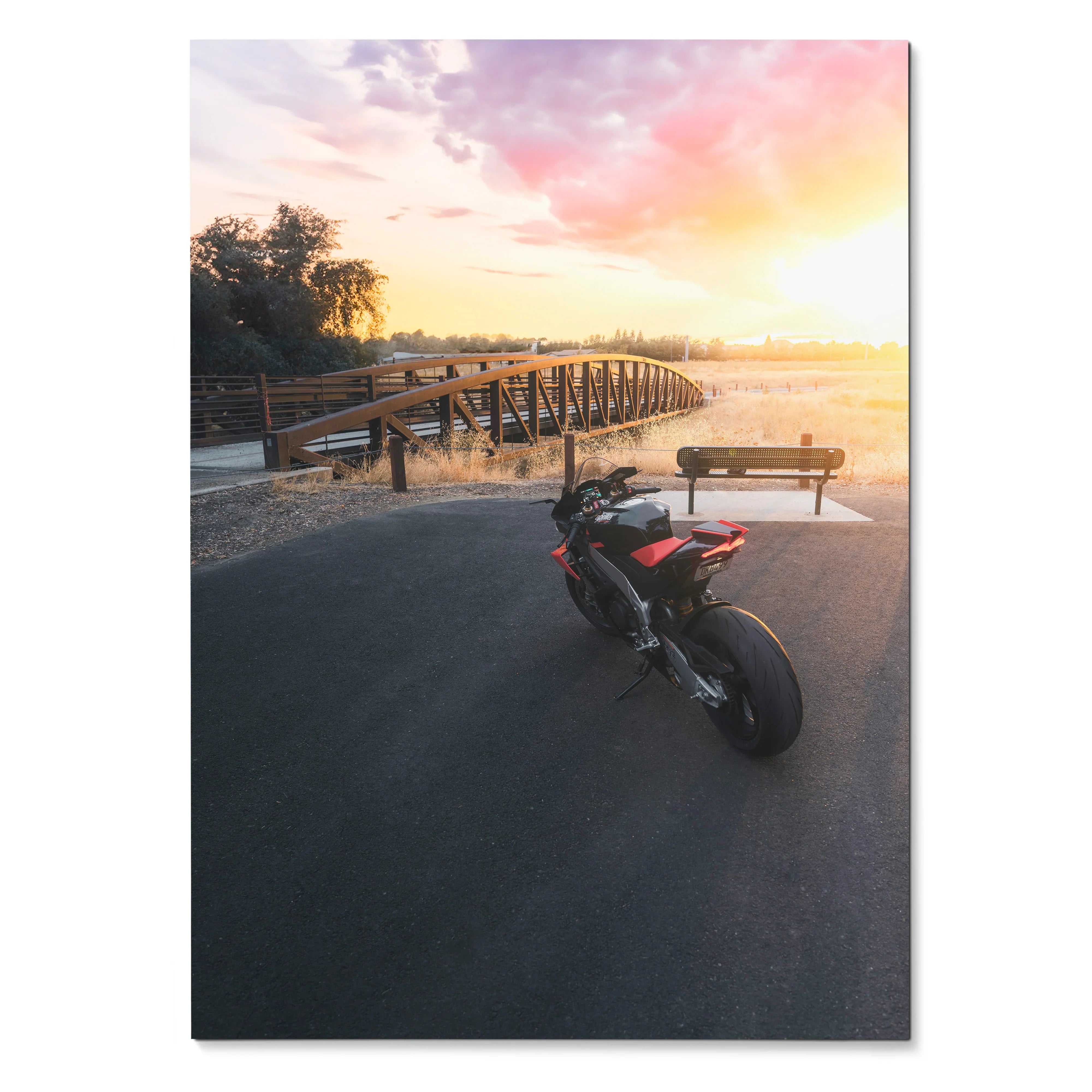 Aprilia RSV4 motorcycle parked near wooden bridge at sunset poster wall art.