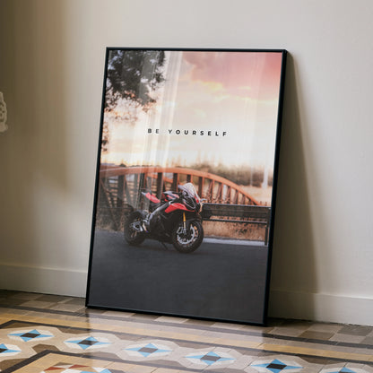 Motivational poster wall art featuring Aprilia RSV4 1100 Factory motorcycle by a bridge at sunset.