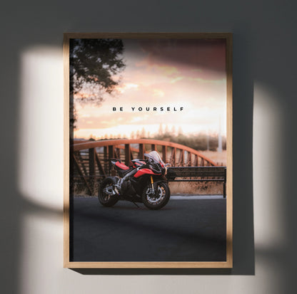 Motivational poster wall art featuring Aprilia RSV4 1100 Factory motorcycle at sunset with "Be Yourself" text.