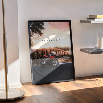 Motivational wall art poster featuring a red Aprilia RSV4 1100 Factory motorcycle with a scenic bridge background and.