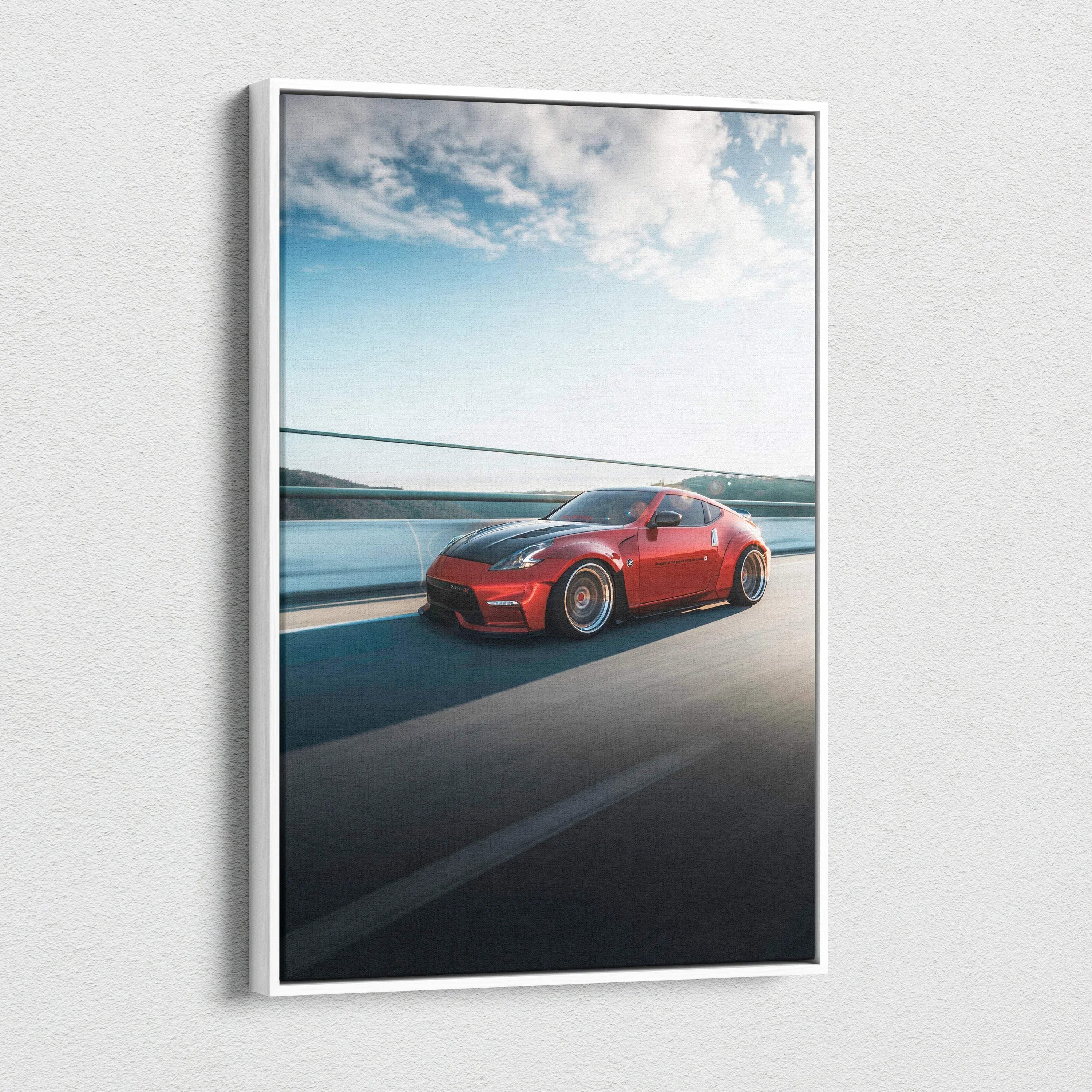 Red Nissan 370z driving on highway blue sky wall art canvas print.