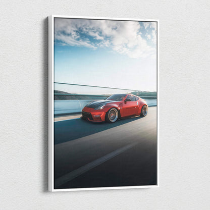 Red Nissan 370z driving on highway blue sky wall art canvas print.