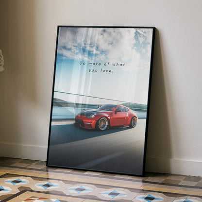 Motivational poster wall art featuring a red Nissan 370z on a road with inspiring text and a blue sky background.