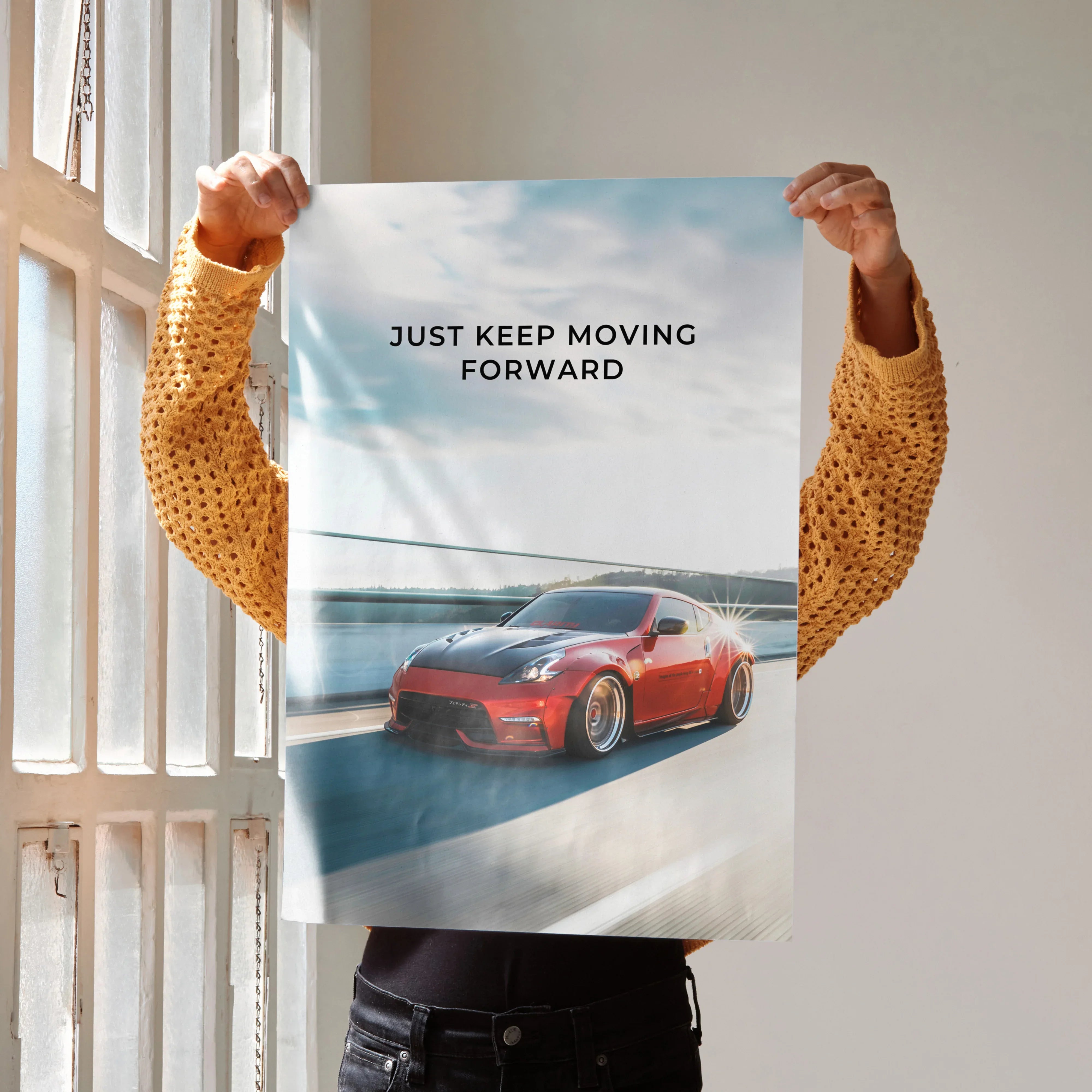 Motivational poster wall art featuring a red Nissan 370z racing on a road with "Just Keep Moving Forward" text.