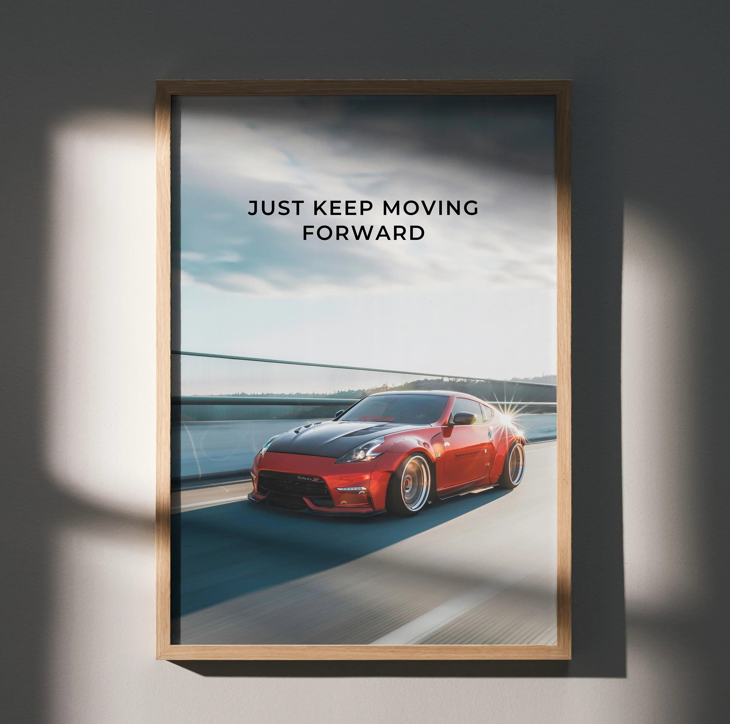 Motivational poster featuring red Nissan 370z on bridge with "Just Keep Moving Forward" text wall art.