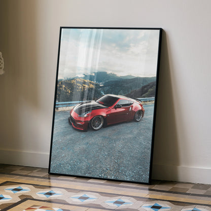 Nissan 370Z red sports car on mountain road poster wall art in black frame.