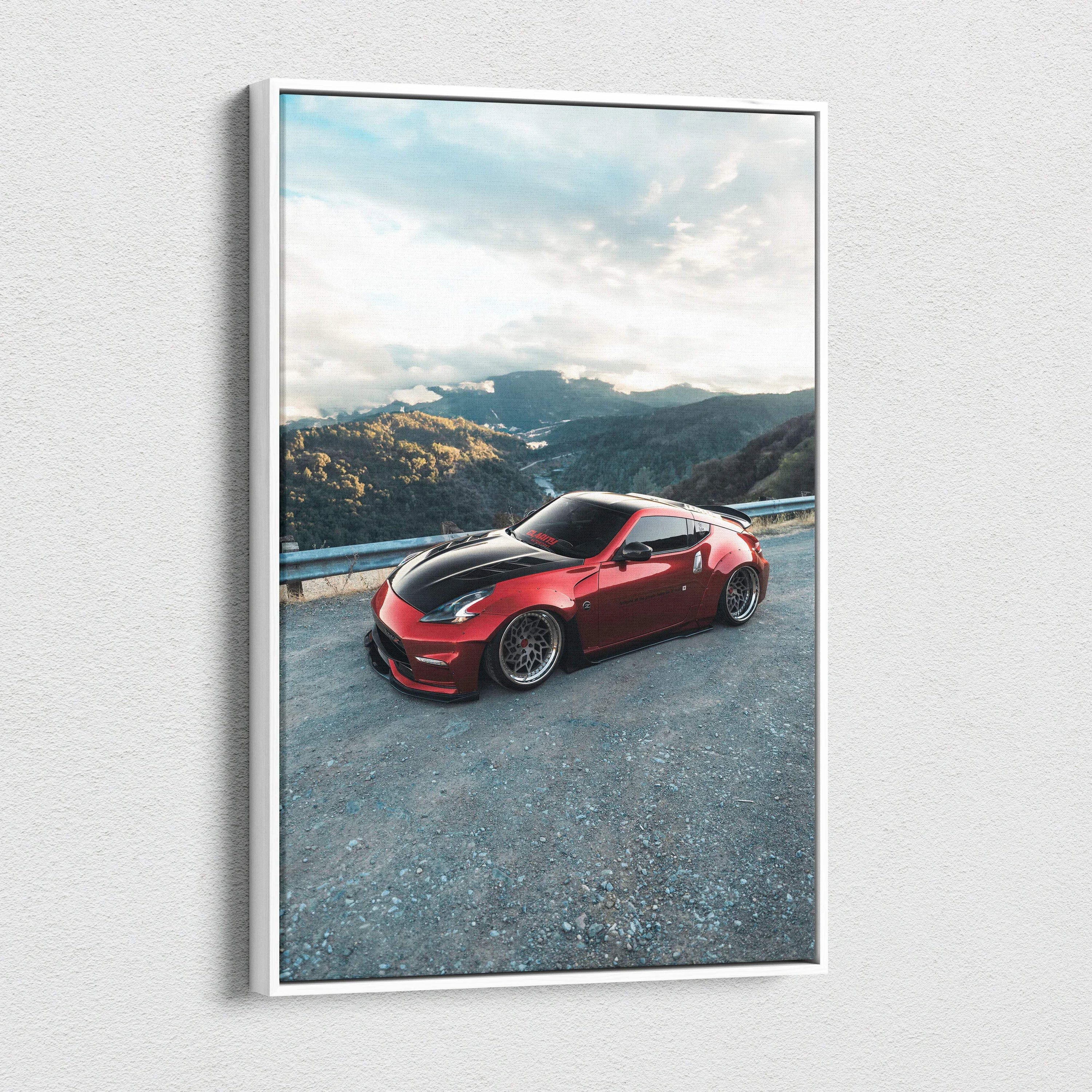 Red Nissan 370z sports car on mountain road canvas wall art with clear sky background.