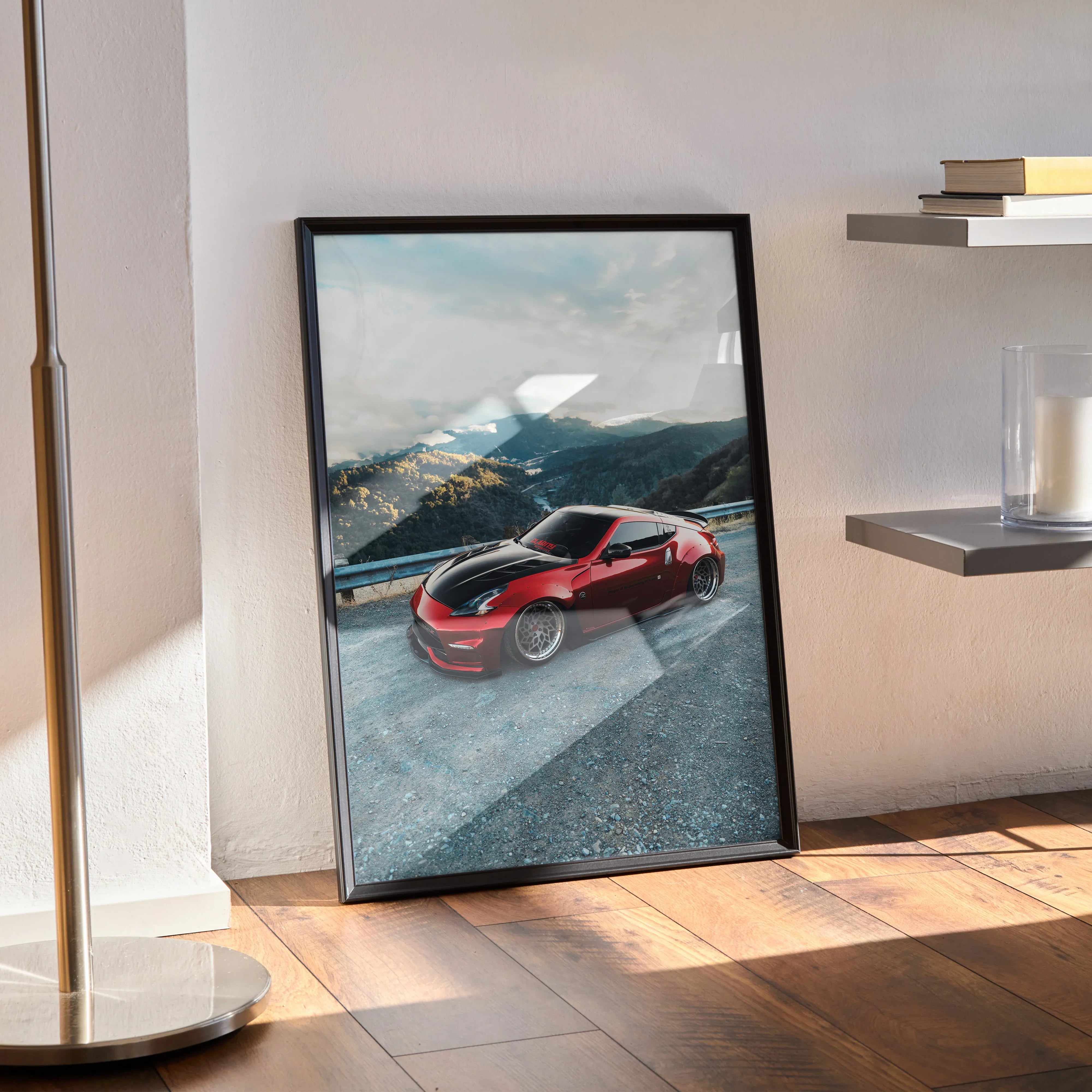 Nissan 370Z red sports car poster wall art with mountain background in black frame.