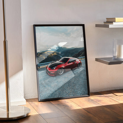 Nissan 370Z red sports car poster wall art with mountain background in black frame.