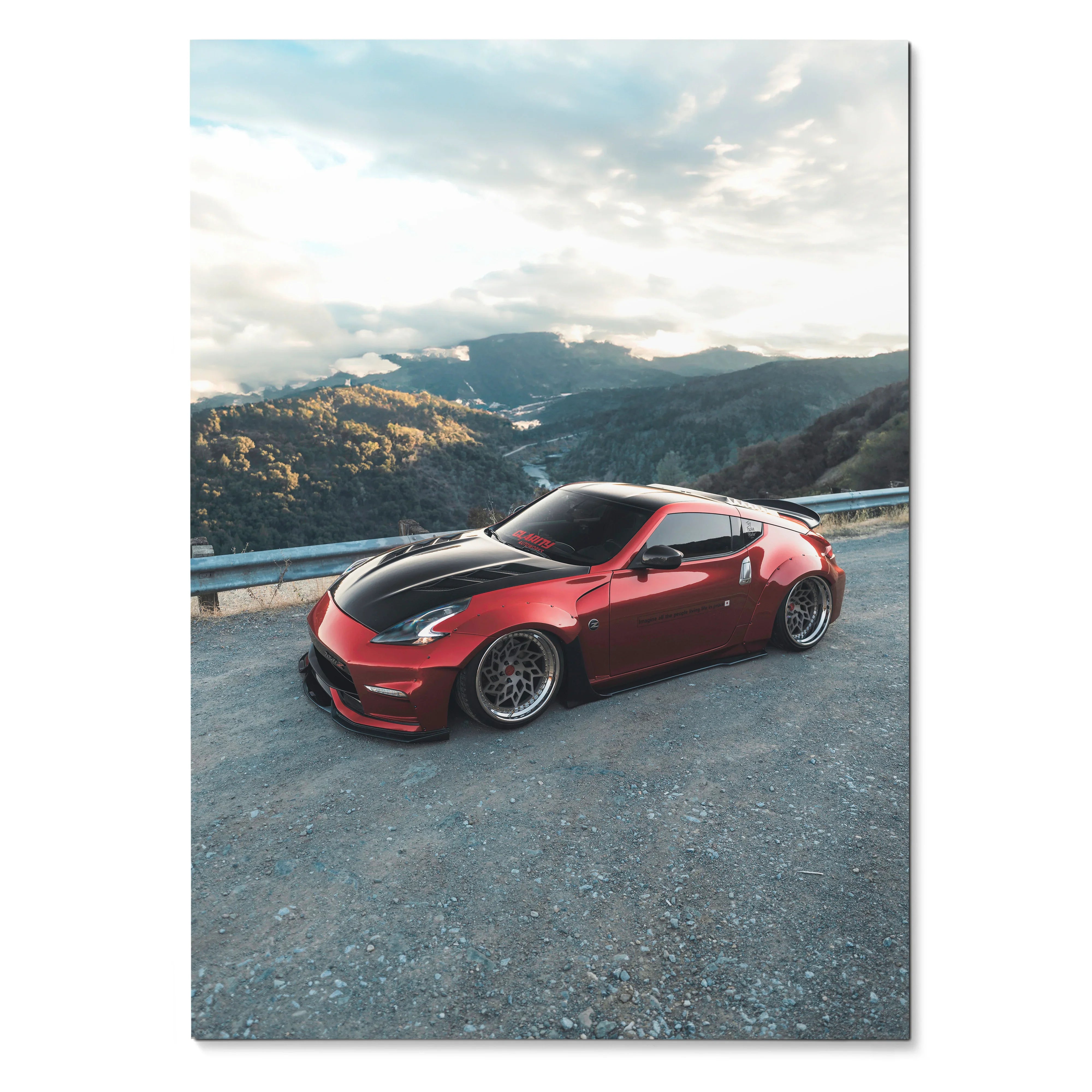Red Nissan 370Z sports car on mountain road poster wall art with scenic background.