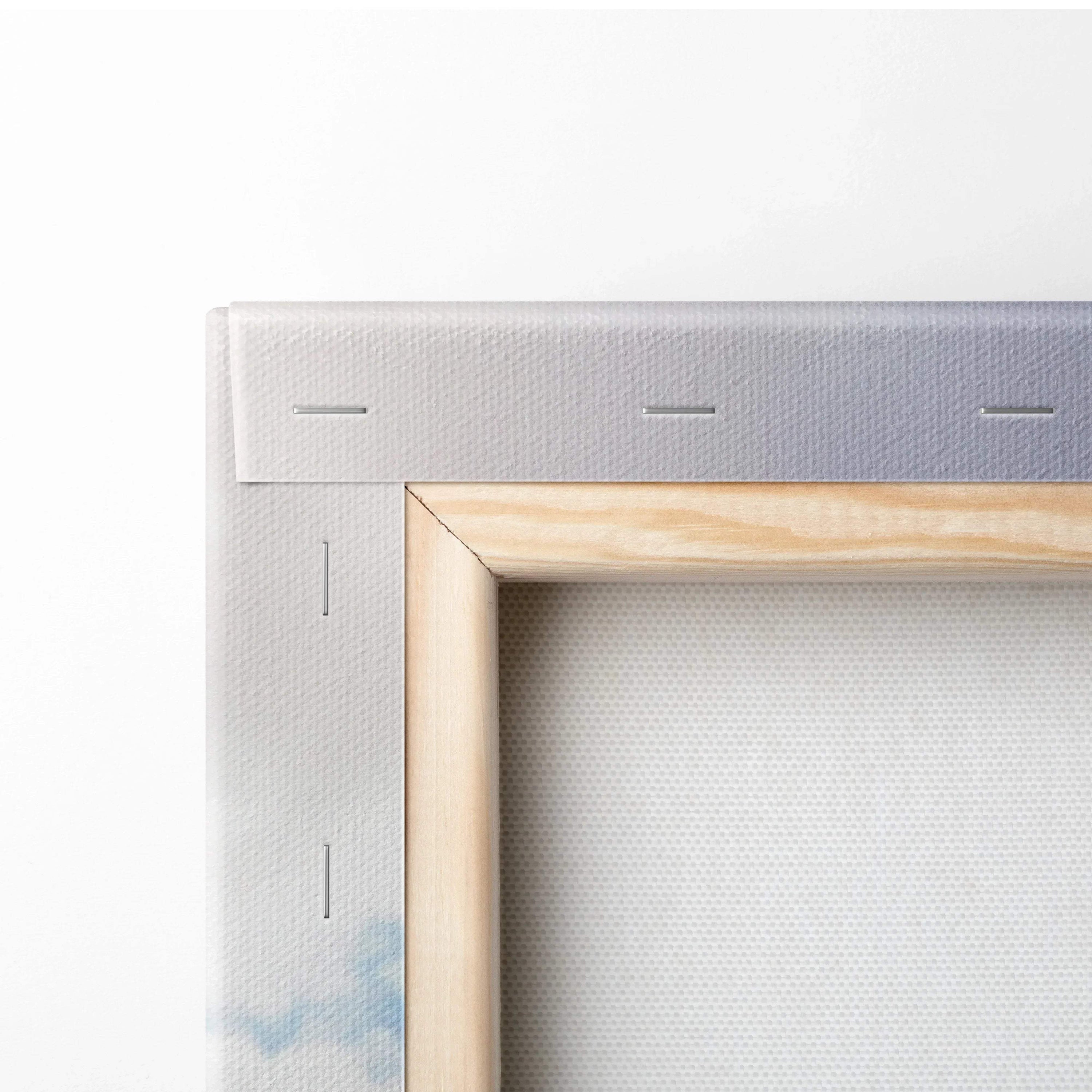 Close-up of stretched canvas wall art with wooden frame and stapled edges.