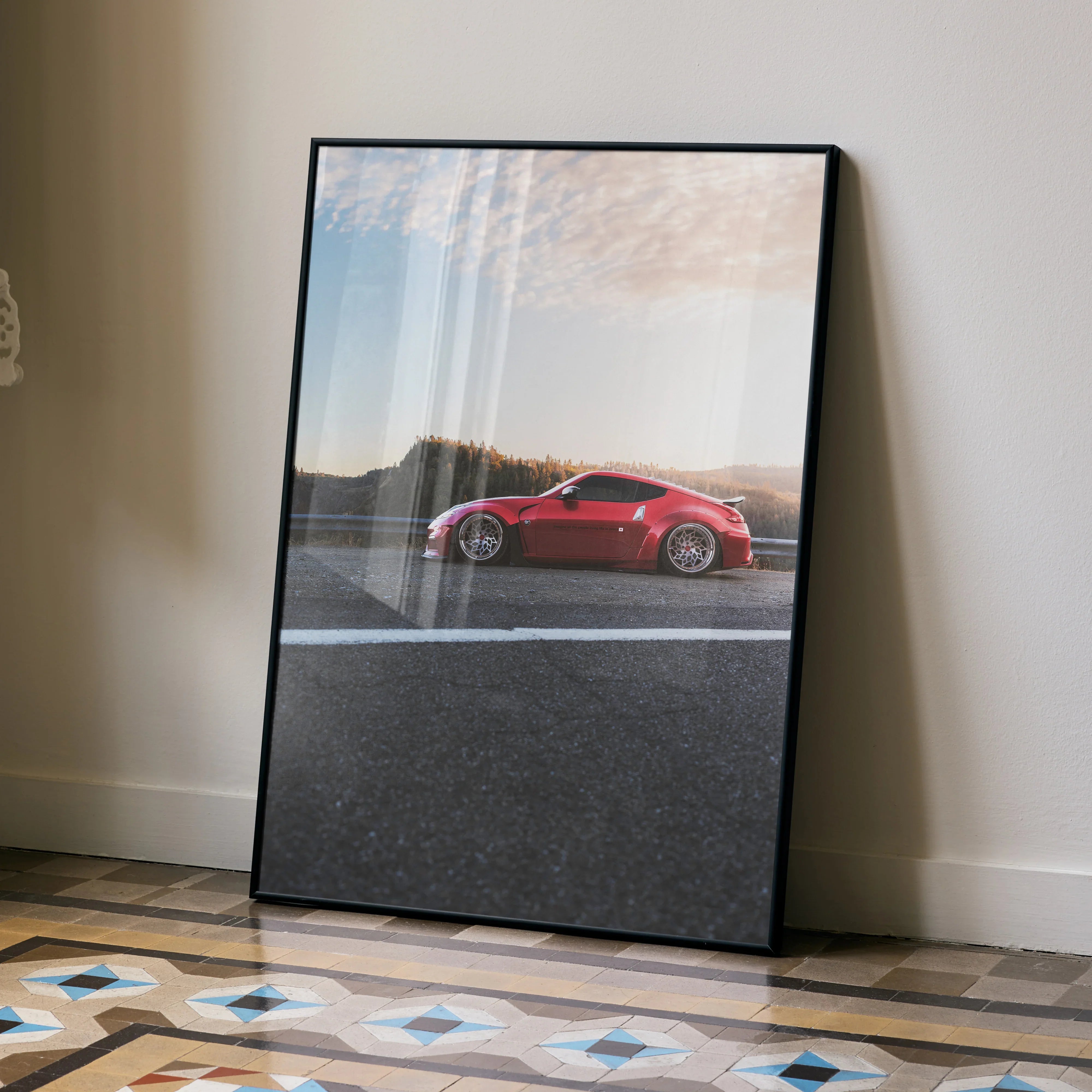 Red Nissan 370Z sports car on asphalt road poster leaning against wall wall art.
