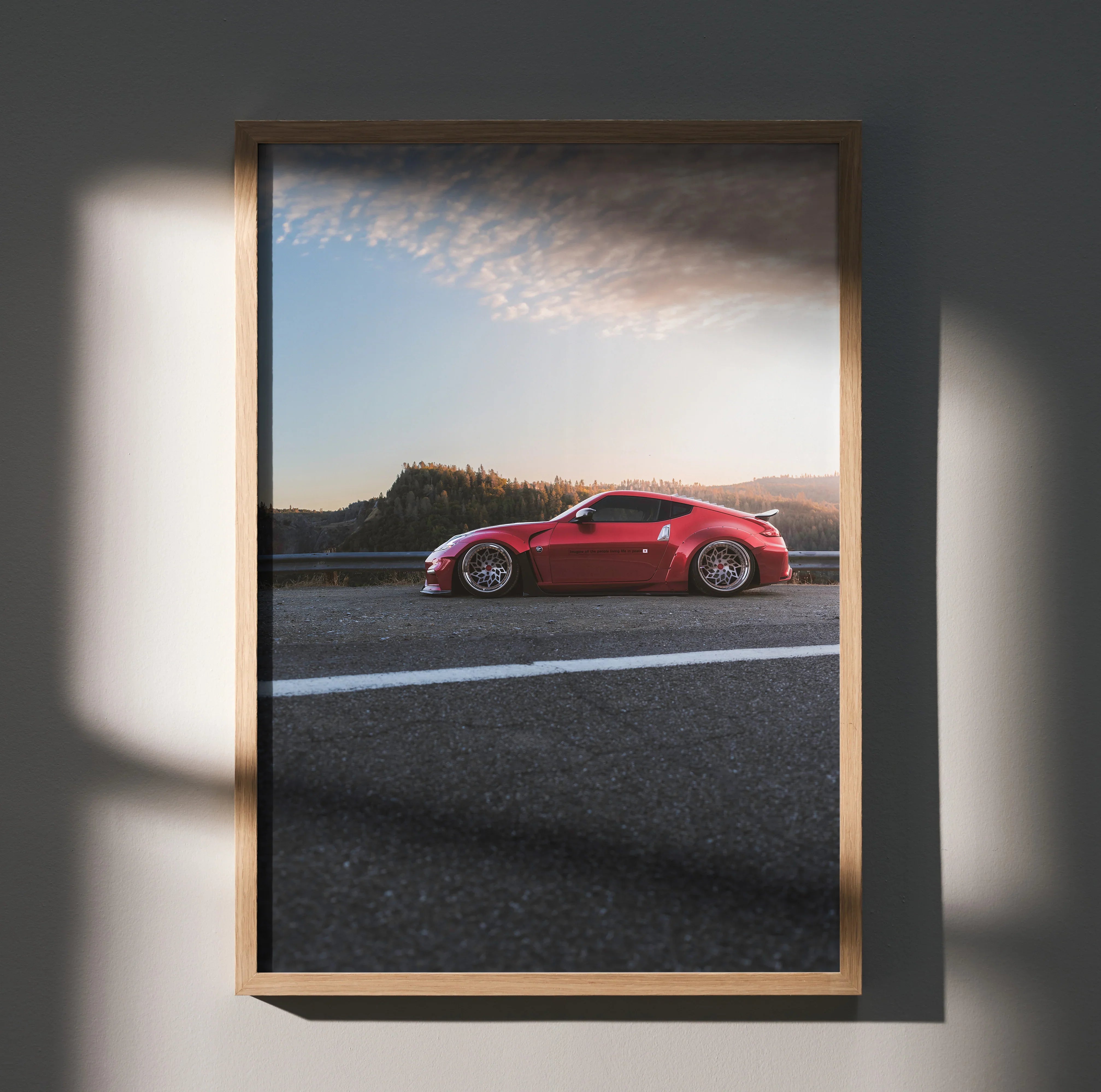 Nissan 370Z red sports car poster with sunset sky and scenic background wall art.