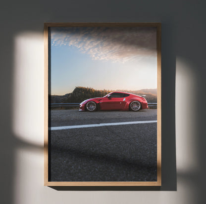 Nissan 370Z red sports car poster with sunset sky and scenic background wall art.