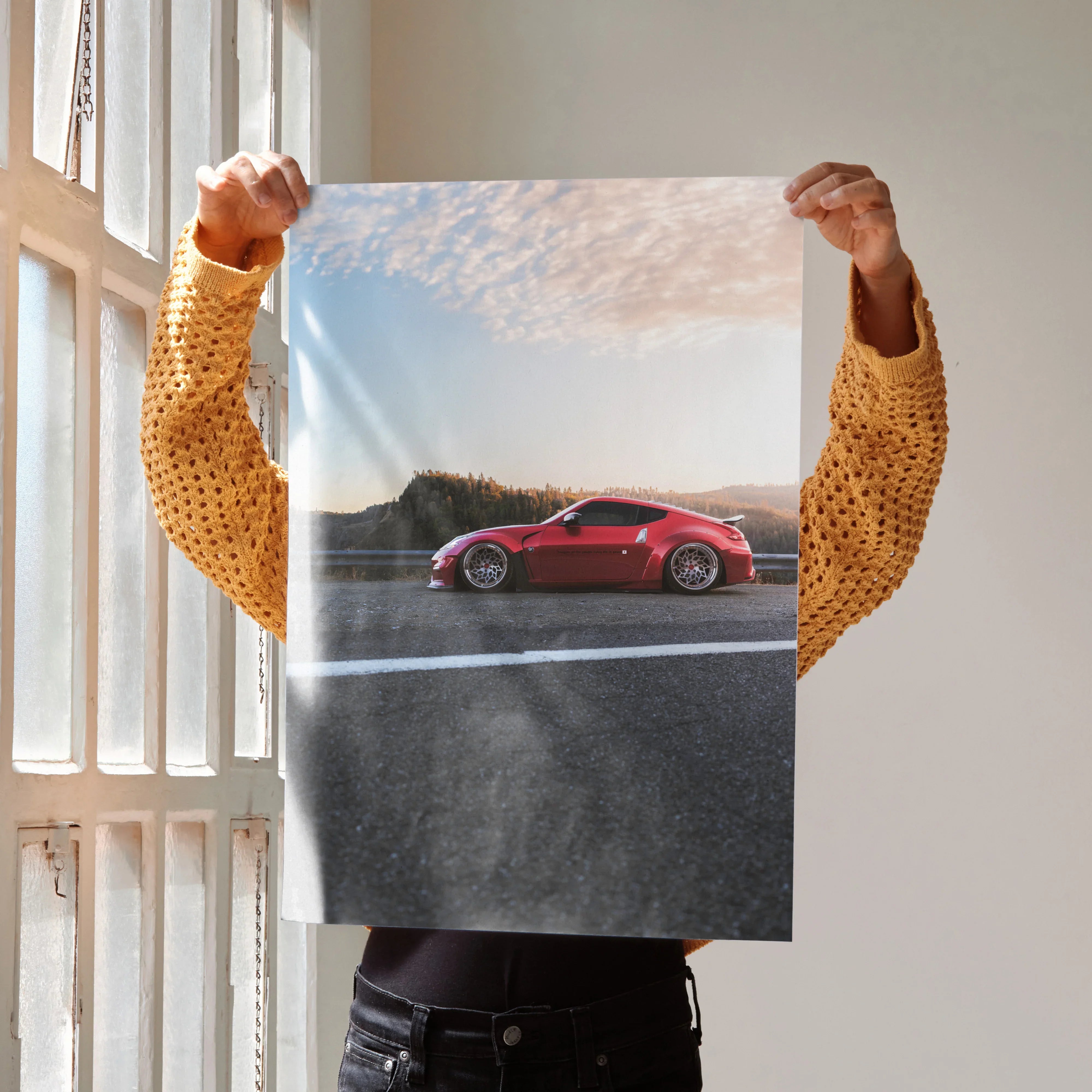 Red Nissan 370Z on road with blue sky, high resolution poster wall art for car enthusiasts.