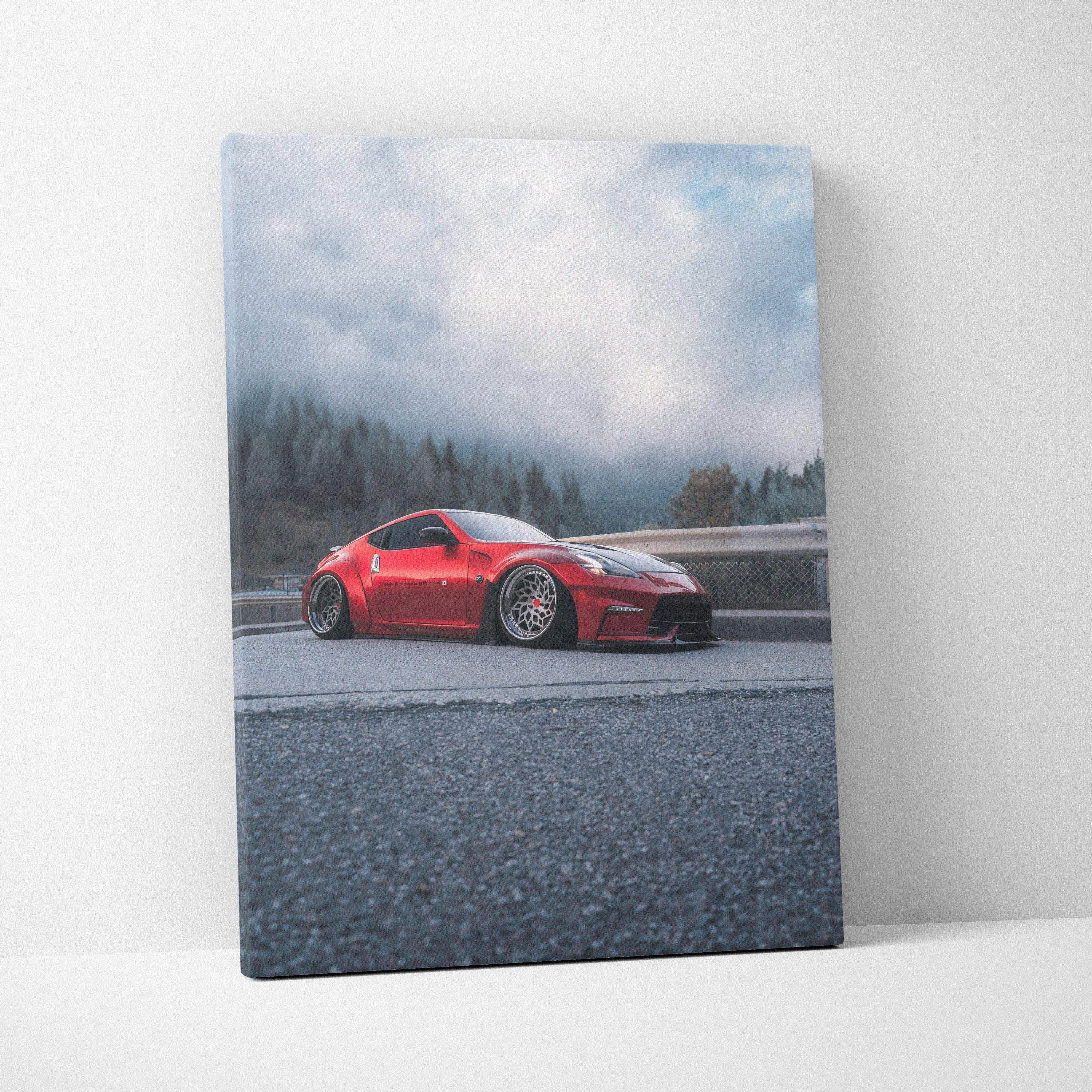 Vertical canvas art of a red Nissan 370z sports car on a foggy mountain road wall art.