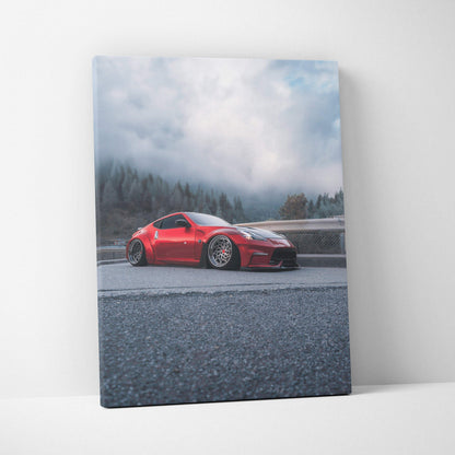 Vertical canvas art of a red Nissan 370z sports car on a foggy mountain road wall art.