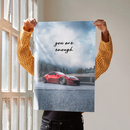 Motivational poster wall art with red Nissan 370z on wet road and "you are enough" text.