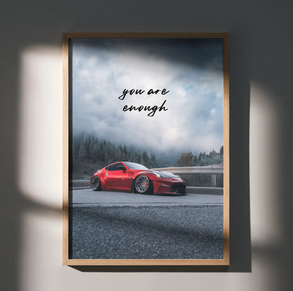 Motivational poster wall art featuring a red Nissan 370z on a foggy mountain road with "you are enough" text.