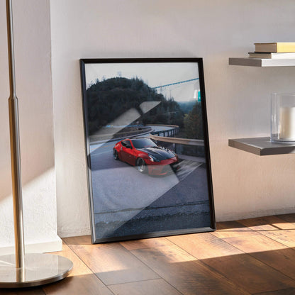 Nissan 370z poster wall art in black frame leaning on floor with modern shelving and sunlight.