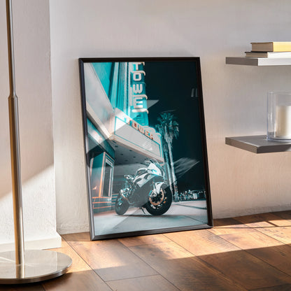 BMW S1000RR motorcycle poster leaning against wall with retro neon sign, stylish wall art in black frame.