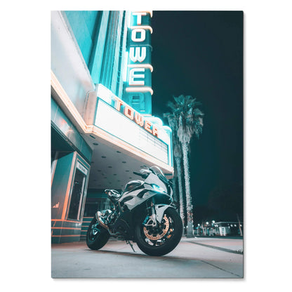 BMW S1000RR motorcycle parked under neon-lit vintage tower sign at night poster wall art.