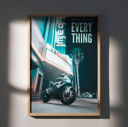 Motivational poster wall art featuring a BMW S1000RR motorcycle under neon tower sign at night.