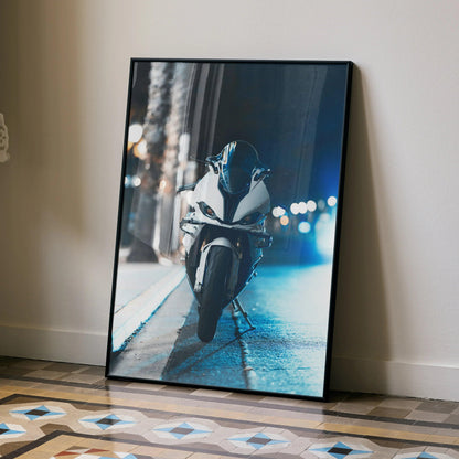 BMW S1000RR motorcycle poster leaning against wall with night city lights, modern wall art.