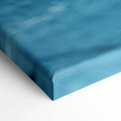 Close-up of textured blue canvas art corner with smooth edges and vibrant color for wall art display.
