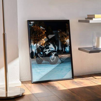 BMW S1000RR motorcycle art print in black frame leaning against wall on wooden floor, poster wall art.