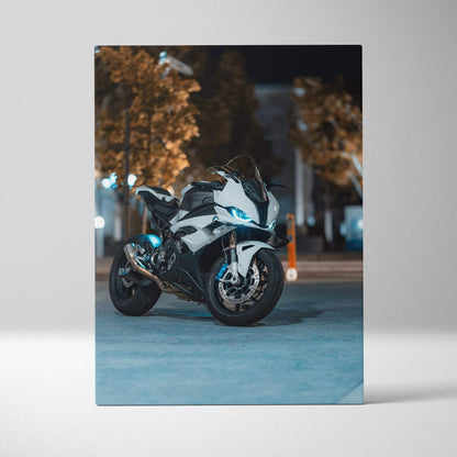 BMW S1000RR motorcycle canvas wall art with blue headlights in urban night setting.