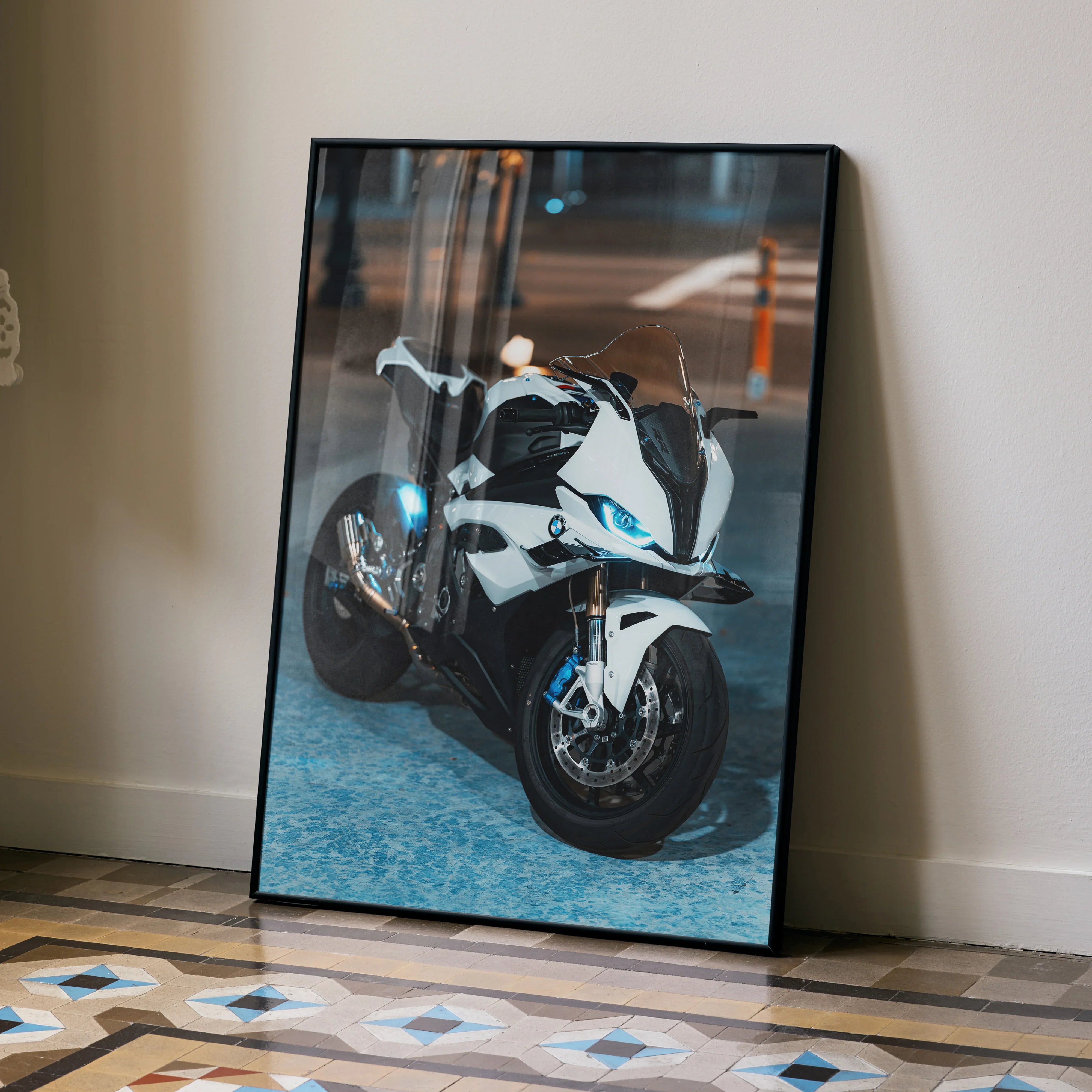 BMW S1000RR motorcycle poster wall art with sleek white and blue racing design, displayed on floor against wall.