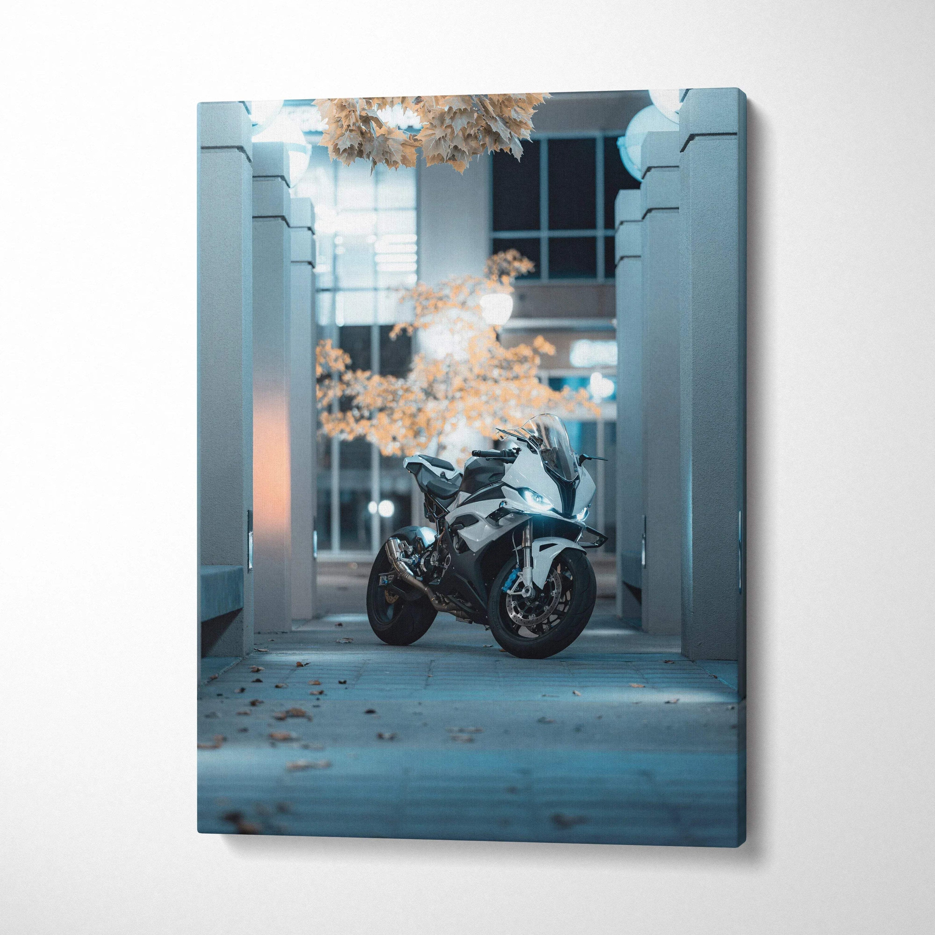 BMW S1000RR motorcycle canvas wall art with cool blue lighting and urban architectural background.